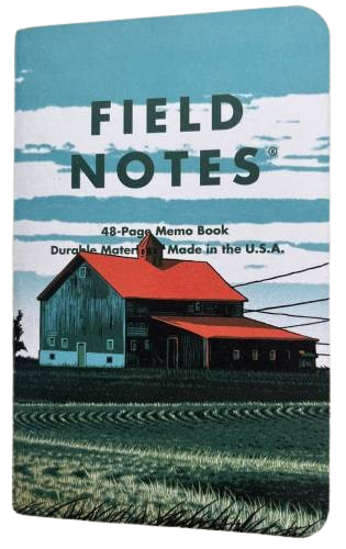 small notebook with a barn on the cover and blue skies