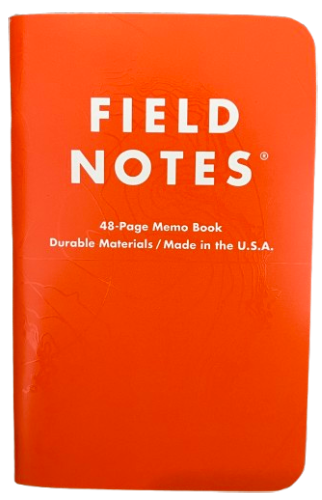 small notebook with a shiny orange cover.
