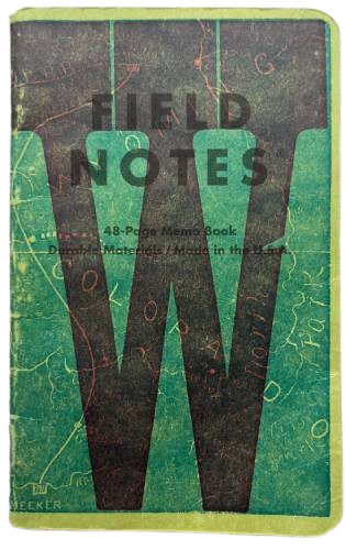 small notebook with a green and black cover