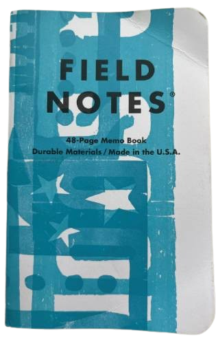 small notebook with a yellow cover and big red lettering