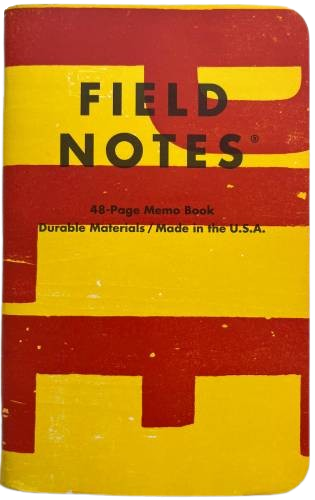 small notebook with a yellow cover and big red lettering